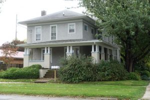 Cosmetic changes to this former Italianate included a new porch in the Craftsman style around 1915.