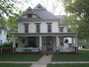 As another former Italianate, this house has been restyled at least twice. First remodeled in the Queen Anne manner (hipped roof with ornate gables), it was later updated in the 1910's with a Colonial Revival front porch. The 6/6 windows are a late 20th century alteration.