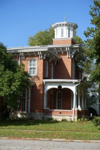 Only the lower (balustrade-height) section of this Italianate porch was altered when brick was utilized to simplify its appearance it in the early 20th century. It is probable that the original wood columns either continued to the porch floor or rested upon wood pedestals. A low wood balustrade may have also been present.