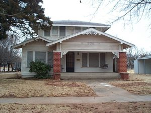 This Craftsman-style house has been outfitted with lacy scrollwork. Such trim is antithetical to the straight-forward expression of structure which is inherent to the style.