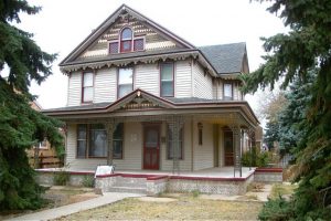 This house actually is a Queen Anne, but has been altered and supplemented in a manner which is not characteristic of the style. Many of the decorations seen here, including the scroll-sawn "bargeboard", gable ornaments, brackets, cast iron porch supports and patterned foundation tiles, date to a renovation sometime around 1970.