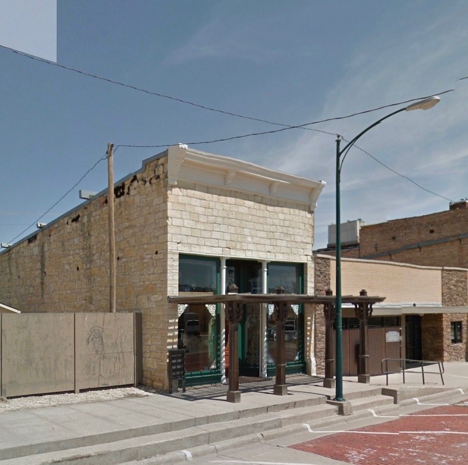 With the fake facade gone, the true proportions and scale of an historic storefront grace the street again.